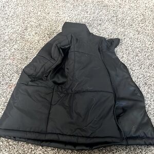 A black puffer vest